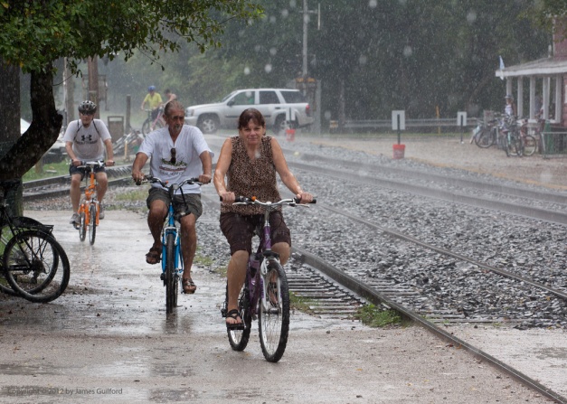 Photo: Cyclists riding in heavy rain. Photo by James Guilford.