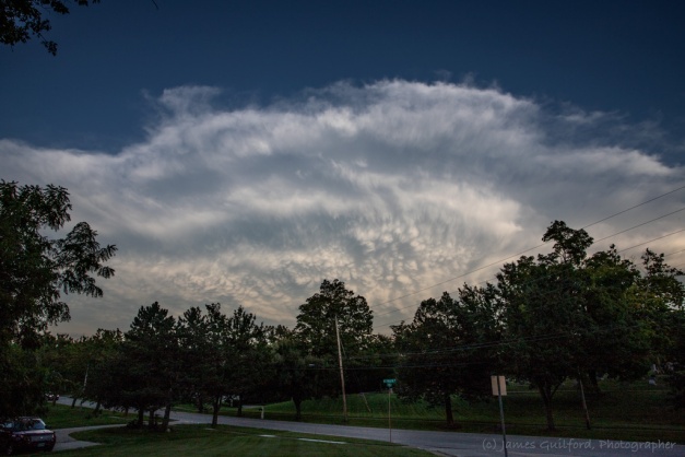 Photo: The thunderhead of a passing storm with mounds of mammatus clouds beneath. Photo by James Guilford.
